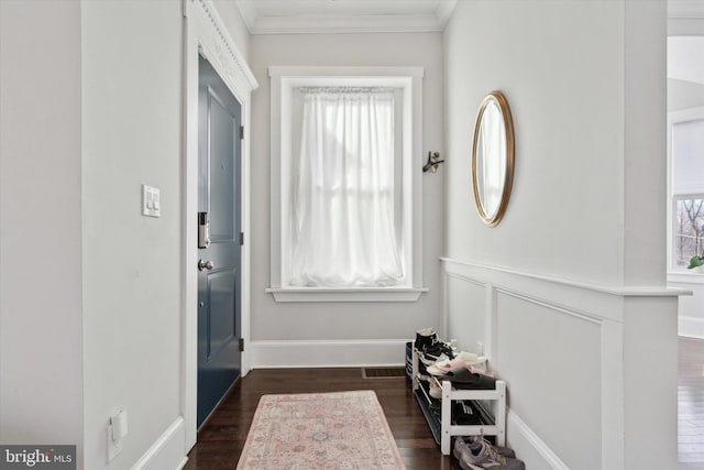 entryway featuring dark hardwood / wood-style flooring and crown molding