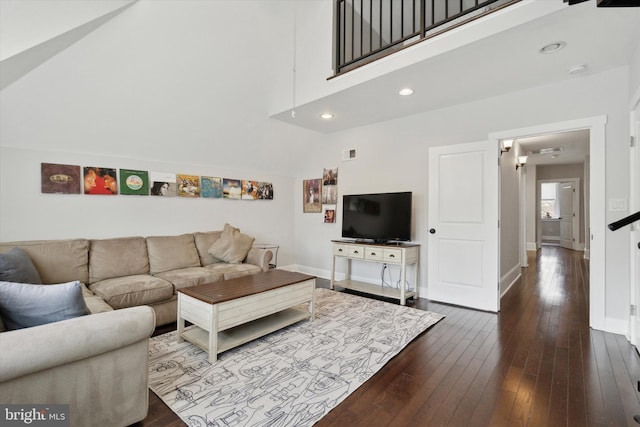 living room featuring hardwood / wood-style floors and high vaulted ceiling