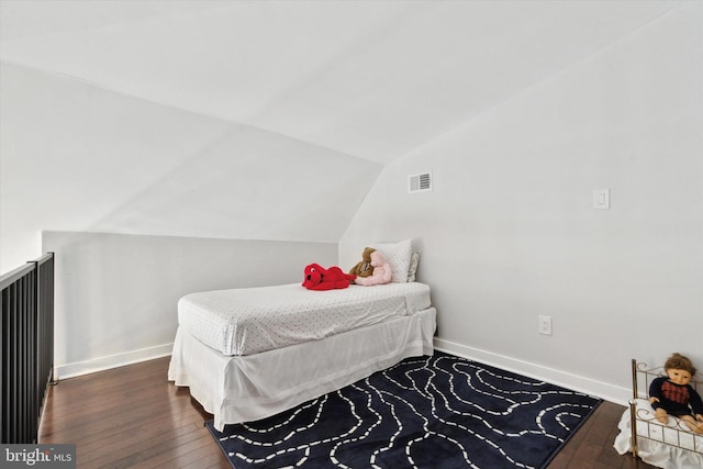 bedroom featuring dark hardwood / wood-style floors and vaulted ceiling