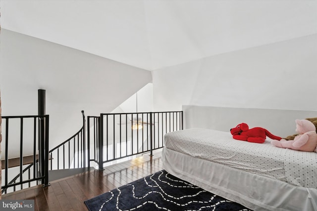 bedroom featuring hardwood / wood-style floors and vaulted ceiling