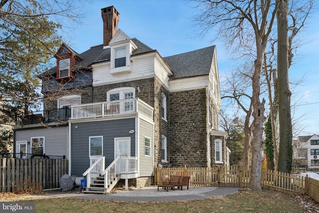 back of house with a patio area and a balcony