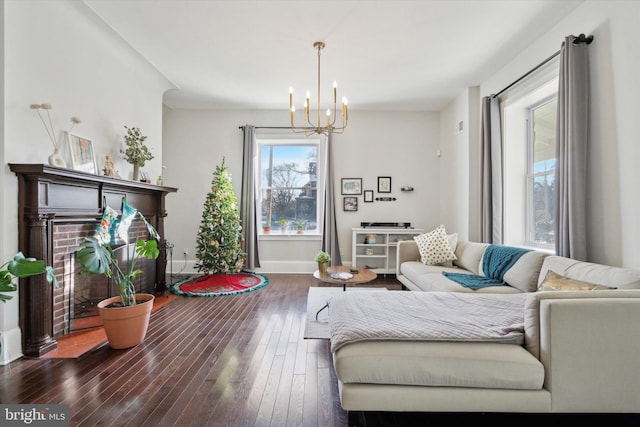 living room with dark hardwood / wood-style flooring and a chandelier