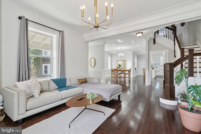 living room featuring a notable chandelier, dark hardwood / wood-style floors, and ornamental molding