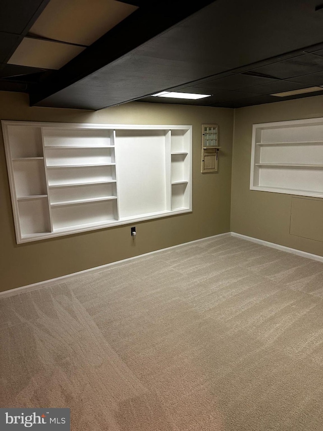 basement featuring built in features and carpet