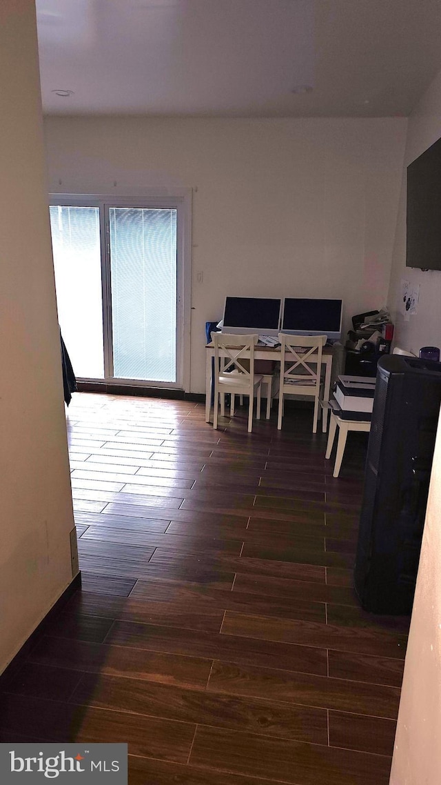 dining space with dark hardwood / wood-style floors and a healthy amount of sunlight