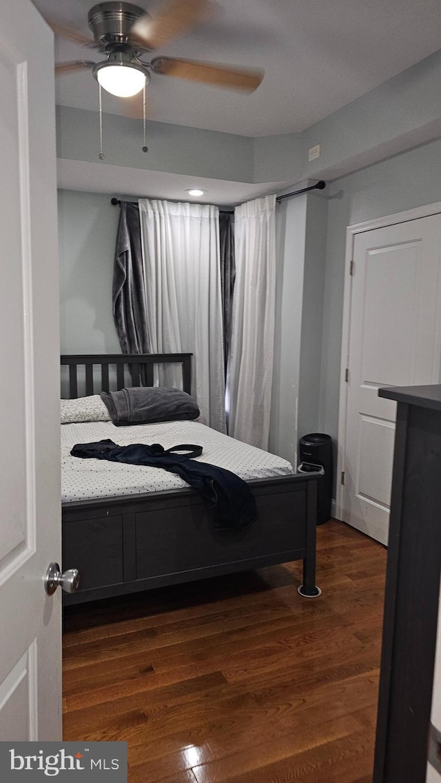 bedroom featuring ceiling fan and dark wood-type flooring