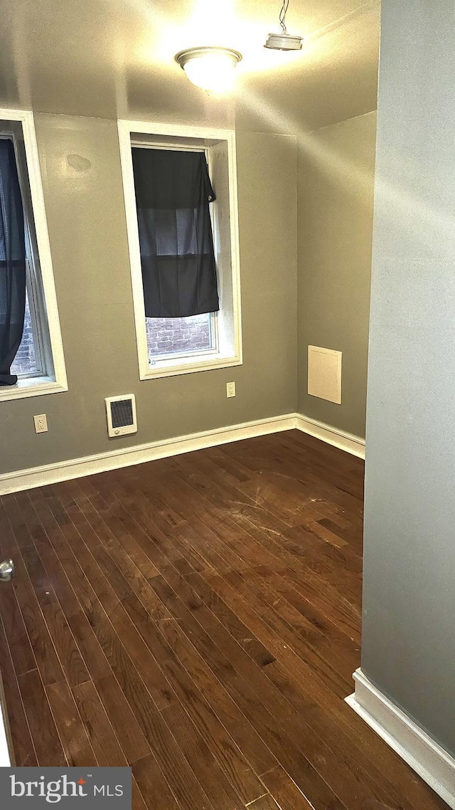 spare room featuring dark hardwood / wood-style floors