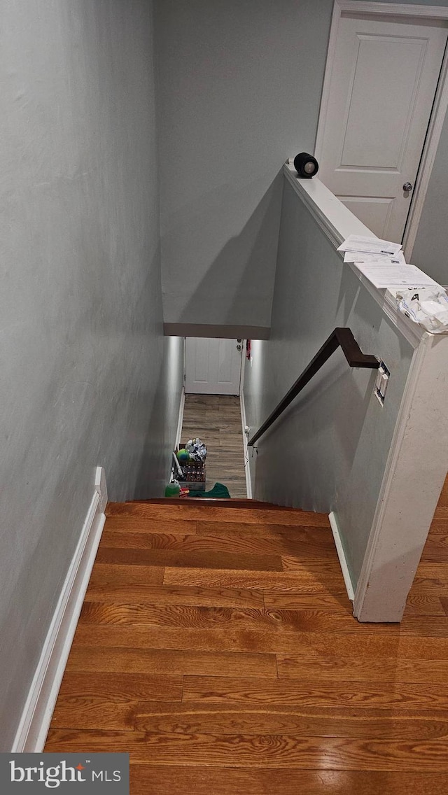 stairway featuring hardwood / wood-style flooring