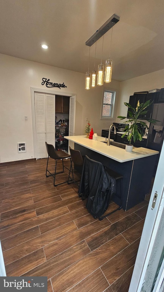 interior space with pendant lighting and sink