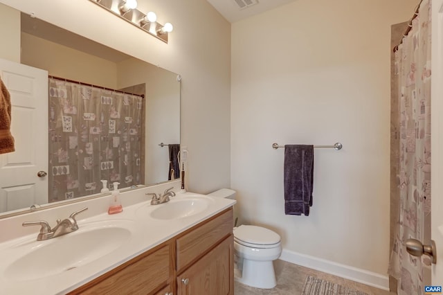 bathroom with tile patterned floors, curtained shower, vanity, and toilet