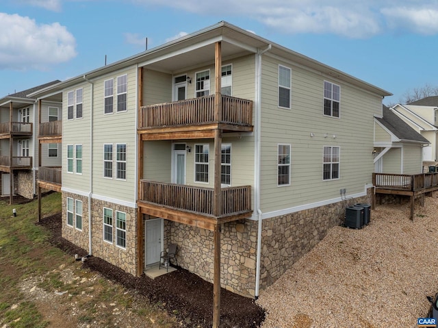 back of house featuring a balcony and central air condition unit