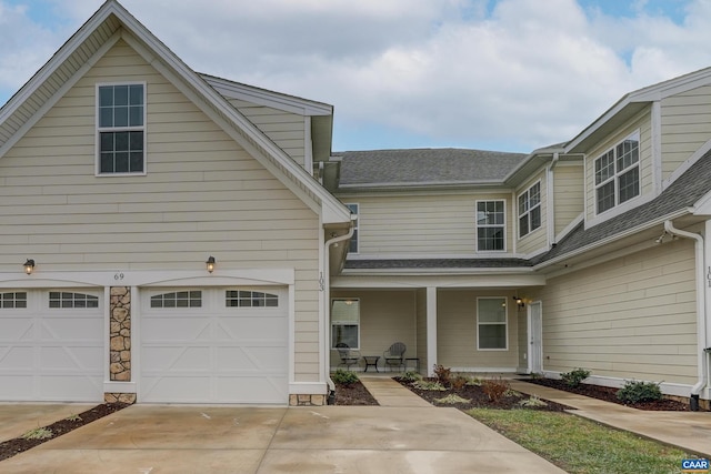 view of front of home with covered porch and a garage