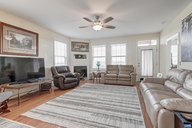 living room featuring light wood-type flooring and ceiling fan