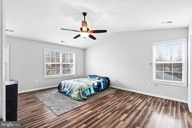 bedroom with multiple windows, ceiling fan, dark hardwood / wood-style flooring, and lofted ceiling