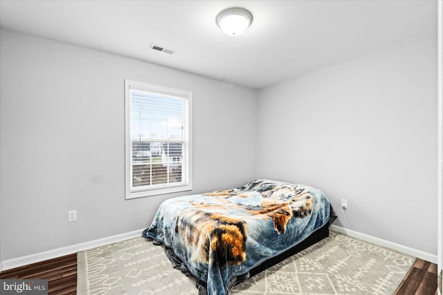 bedroom with hardwood / wood-style flooring