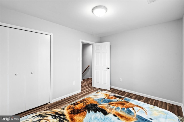 bedroom featuring dark hardwood / wood-style floors and a closet