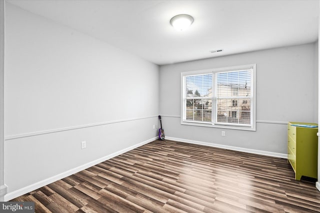 spare room featuring dark hardwood / wood-style flooring