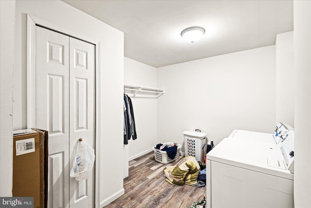 washroom with hardwood / wood-style flooring and separate washer and dryer