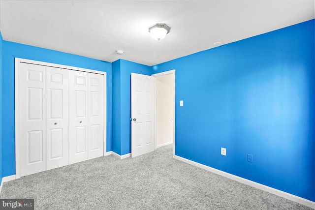 unfurnished bedroom featuring carpet floors and a closet