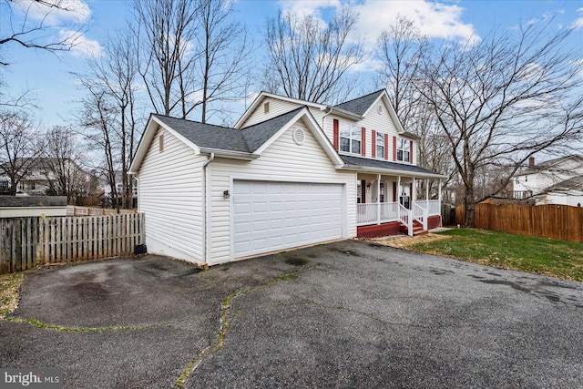 view of front of house with covered porch and a garage