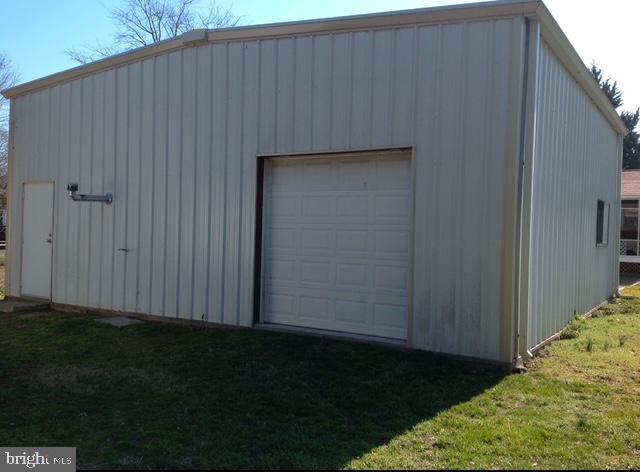 view of outbuilding featuring a yard and a garage