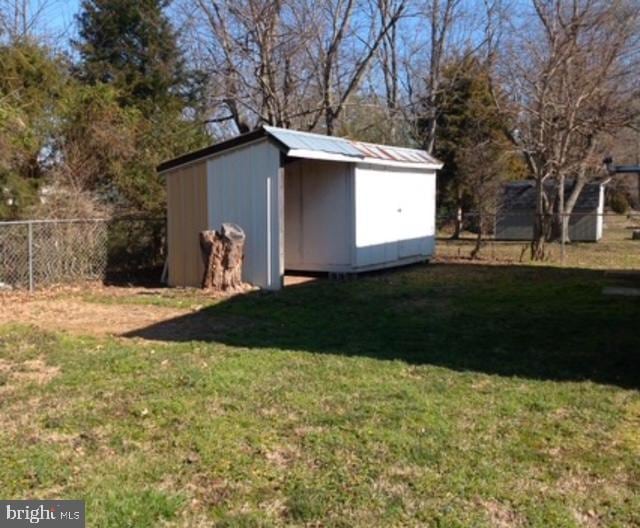 view of outbuilding with a yard