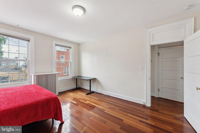 bedroom with dark wood-type flooring