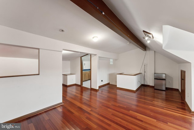 bonus room with vaulted ceiling with beams and dark hardwood / wood-style flooring