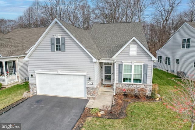 view of front of property featuring a front yard and a garage