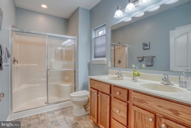 bathroom featuring toilet, an enclosed shower, and vanity