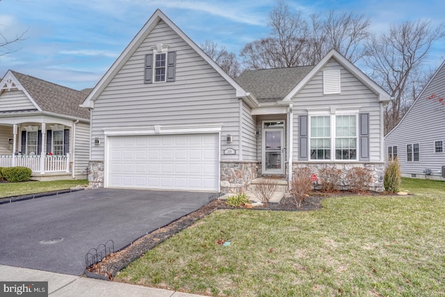 view of front of house with a front yard and a garage