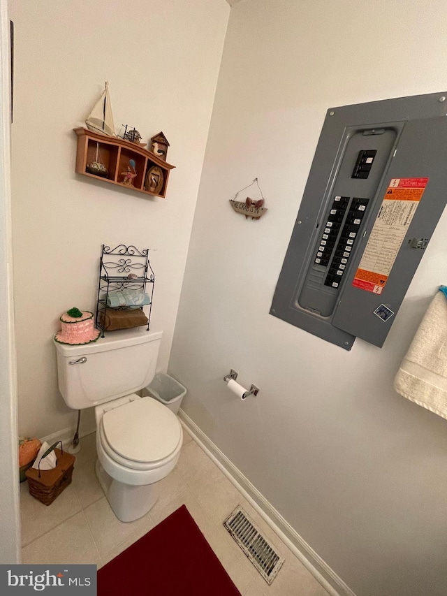 bathroom with toilet, tile patterned flooring, visible vents, and baseboards