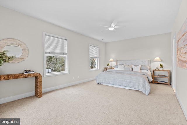 bedroom featuring baseboards, a ceiling fan, and light colored carpet