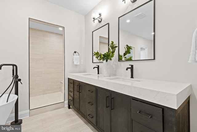 bathroom featuring double vanity, visible vents, a walk in shower, and a sink