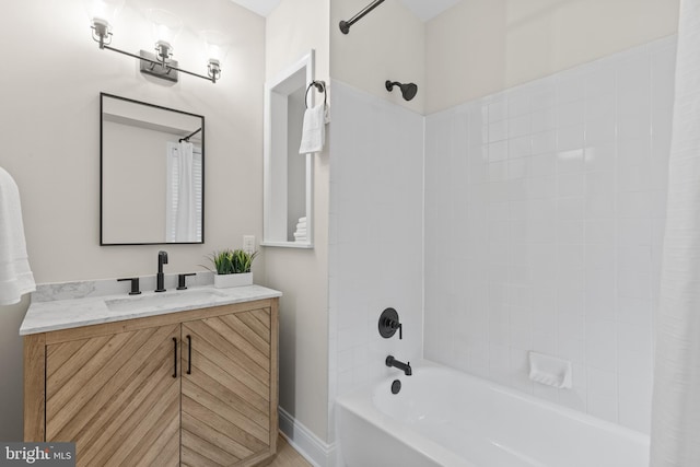 full bath featuring vanity, baseboards, and shower / bathtub combination