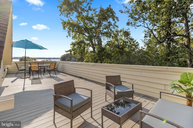 wooden deck with outdoor dining space and an outdoor hangout area