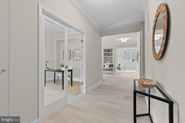 hall featuring ornamental molding, built in features, and baseboards