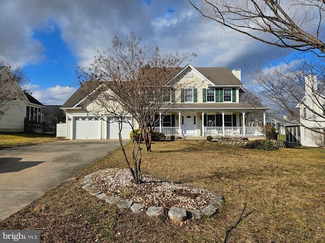 view of front of property featuring a porch, a garage, and a front yard