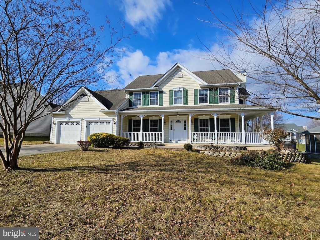 view of front of house with a front lawn, a porch, and a garage