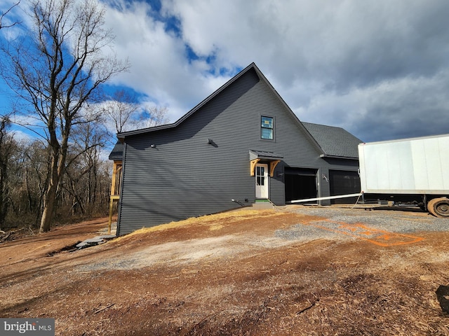 back of house featuring a garage