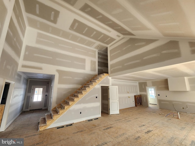 unfurnished living room with plenty of natural light and lofted ceiling