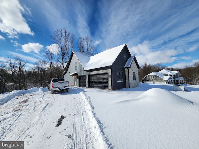 view of snowy exterior featuring a garage