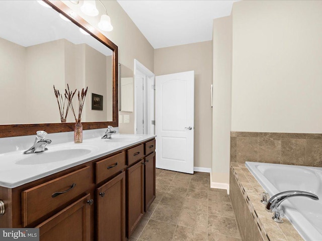 bathroom featuring vanity and tiled tub