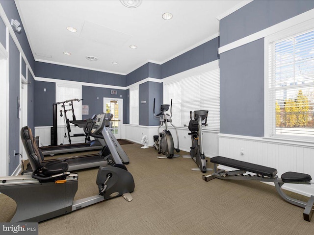 workout area featuring carpet flooring and crown molding