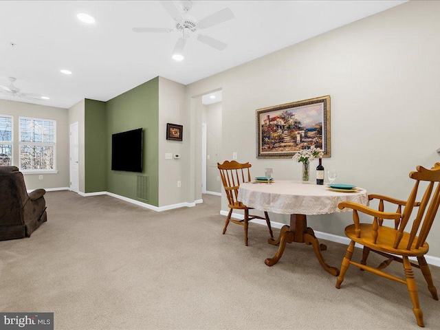 carpeted dining area featuring ceiling fan