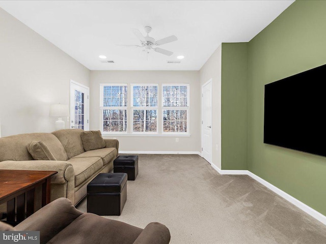 living room with ceiling fan and light colored carpet