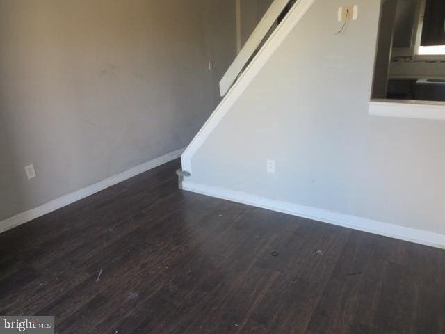 empty room featuring dark wood-type flooring