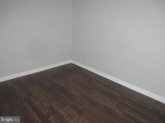 unfurnished room with dark hardwood / wood-style floors