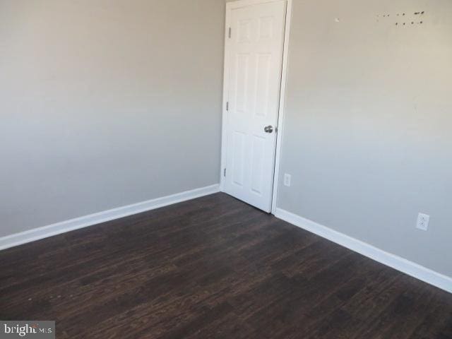 spare room with dark hardwood / wood-style floors