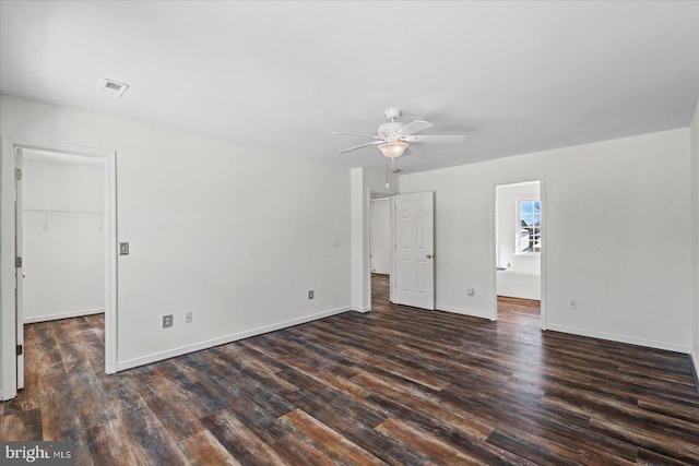 spare room featuring dark wood-type flooring and ceiling fan